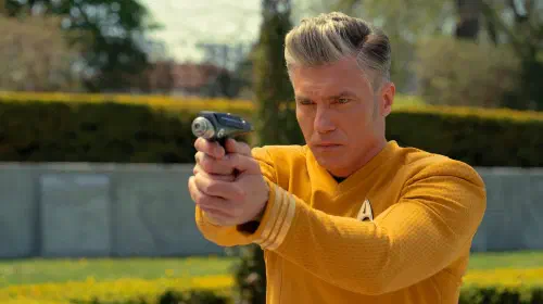 assets/anson-mount-as-captain-pike-aiming-a-phaser-in-star-trek-strange-new-worlds.jpeg