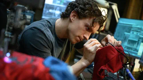 assets/tom-holland-as-peter-parker-repairing-his-suit-in-spider-man-brand-new-day.jpeg