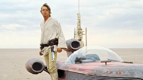 assets/luke-skywalker-standing-next-to-a-speeder-on-tatooine-in-a-new-hope.jpeg