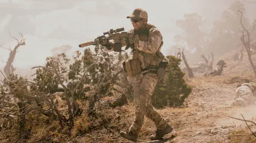 assets/taylor-sheridan-as-cody-holding-a-gun-in-lioness.jpeg