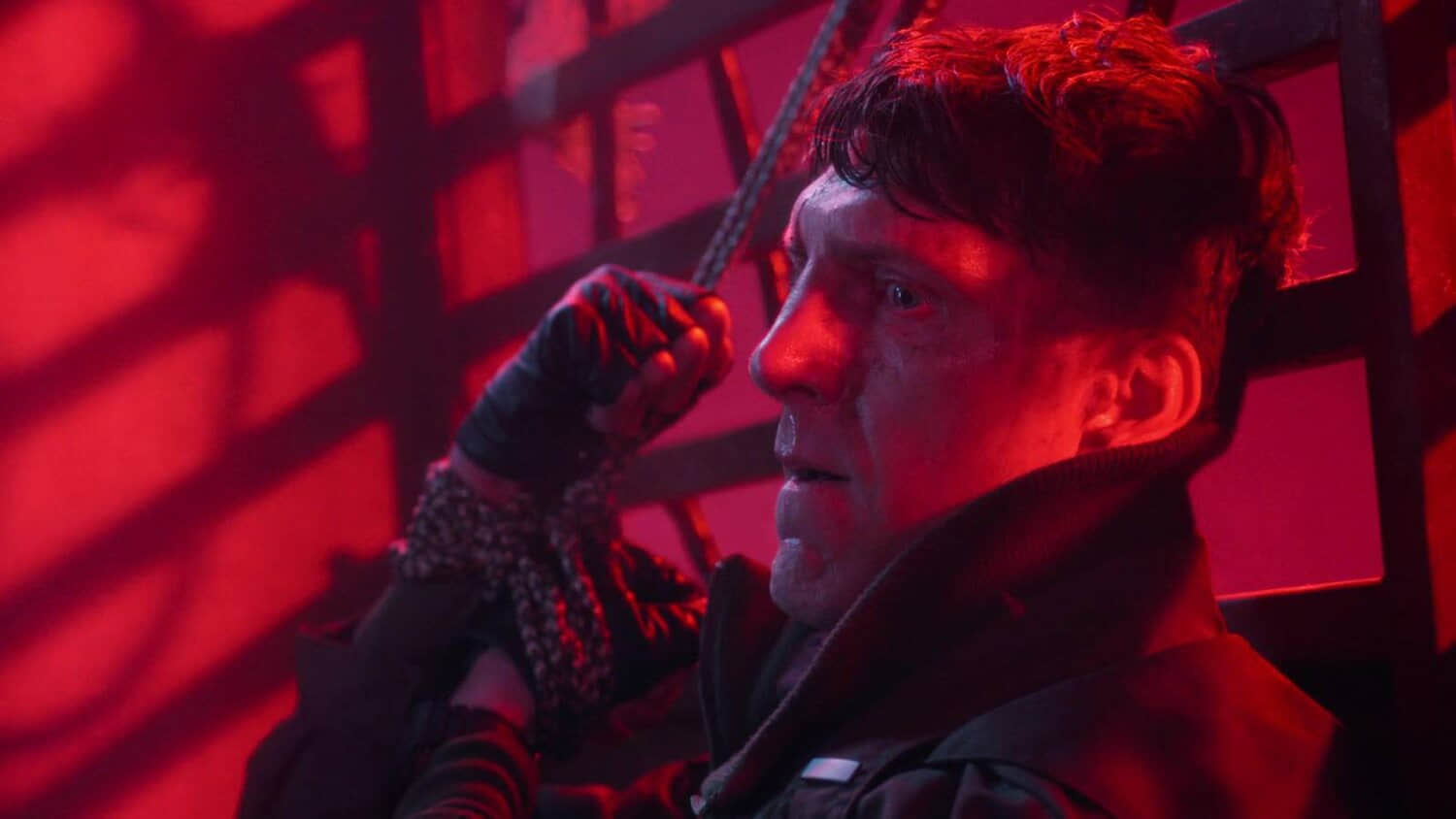 a-man-has-his-hands-tied-in-the-show-stranger-things.jpeg