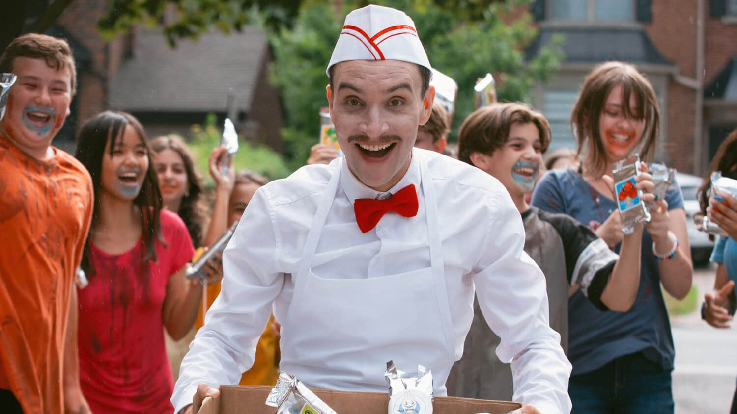 the-ice-cream-man-smiling-as-kids-celebrate-behind-him.jpeg