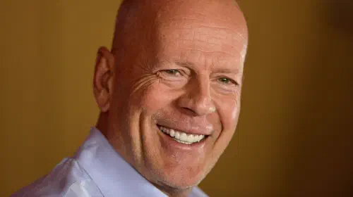 assets/bruce-willis-smiling-for-a-photo-at-an-event.jpeg