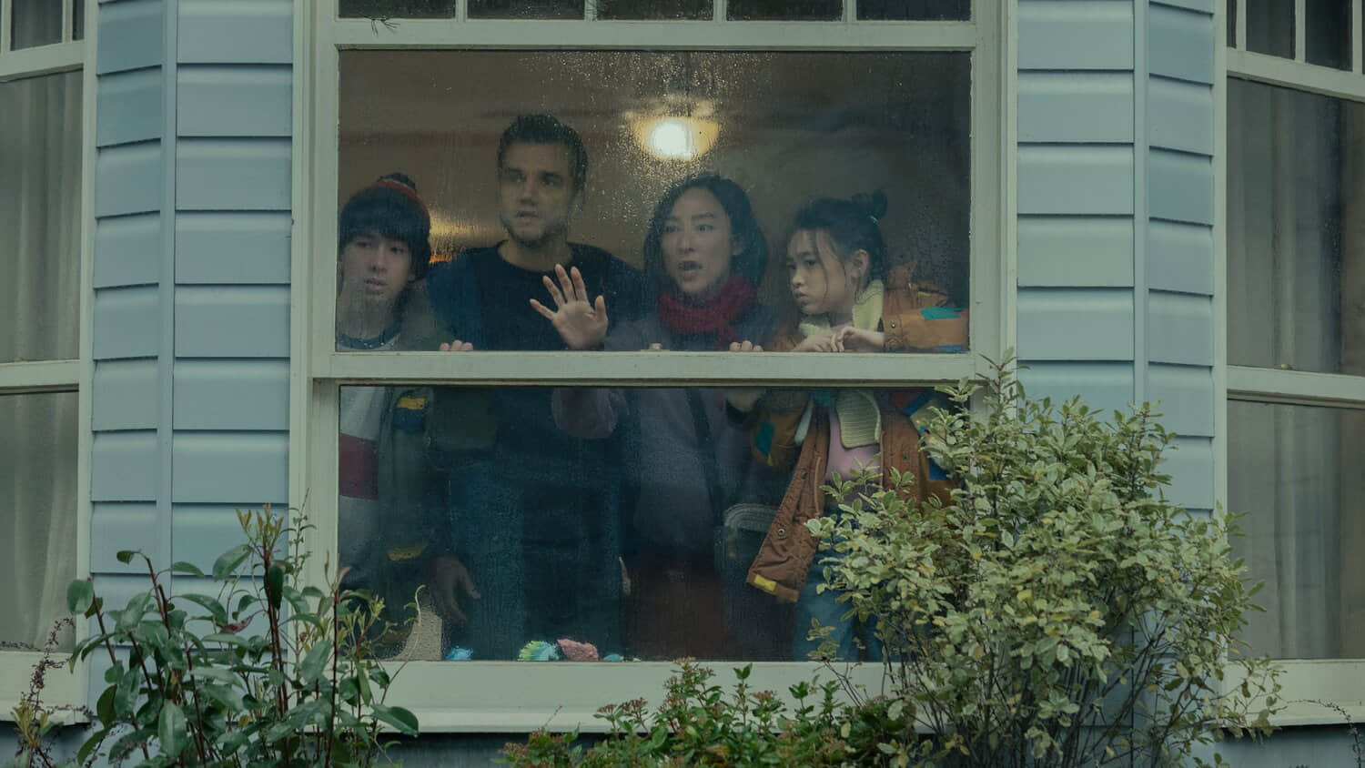 the-trapped-delgados-huddled-around-their-window-in-the-last-house.jpeg