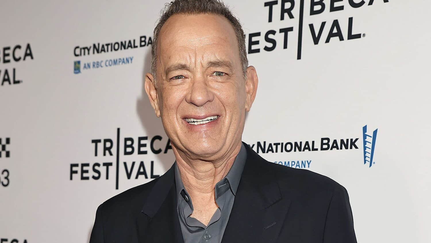 tom-hanks-smiling-on-a-red-carpet-at-the-tribeca-film-festival.jpeg