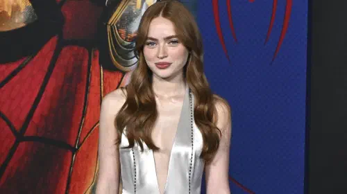 assets/sadie-sink-posing-in-front-of-the-spider-man-brand-new-day-poster.jpeg