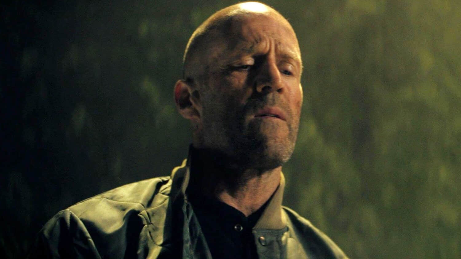 jason-statham-looking-down-at-someone-in-a-working-man.jpeg