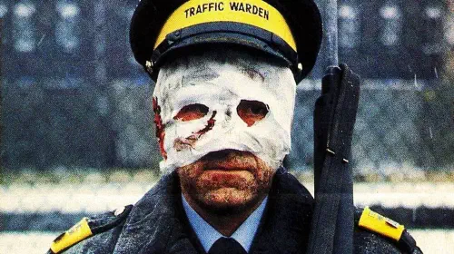assets/an-officer-with-bandages-on-his-face-in-the-film-threads.jpeg