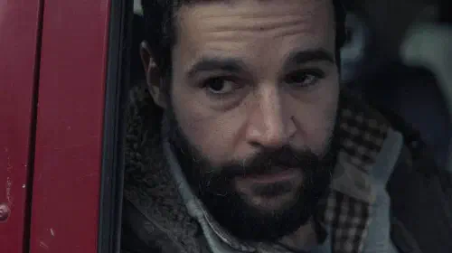 assets/christopher-abbott-in-a-car-seat-in-the-2025-movie-bring-them-down.jpeg