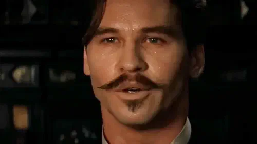 assets/val-kilmer-as-doc-holliday-sweating-in-tombstone.jpeg