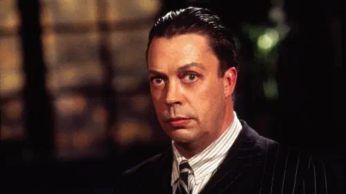 assets/tim-curry-in-the-shadow.jpeg