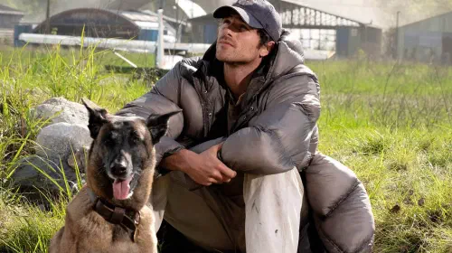 assets/jacob-elordi-sitting-in-a-field-with-a-dog-in-the-dog-stars.jpeg