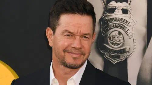 assets/mark-wahlberg-posing-on-the-red-carpet-for-the-premiere-of-by-any-means.jpeg