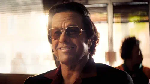 assets/mark-wahlberg-smiling-as-greg-in-by-any-means-1.jpeg