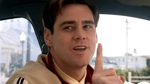 assets/jim-carrey-as-truman-holding-up-a-finger-in-the-truman-show.jpeg