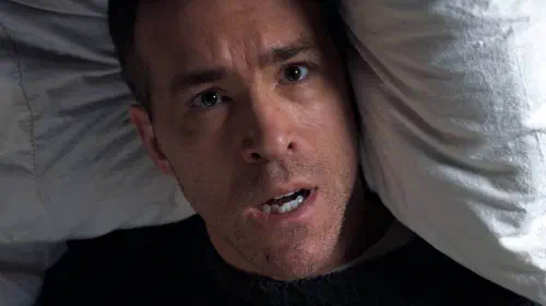 assets/ryan-reynolds-waking-up-in-bed-in-mayday.jpeg