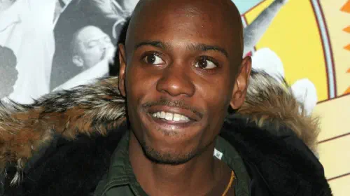 assets/dave-chappelle-posing-on-a-red-carpet-in-2006.jpeg