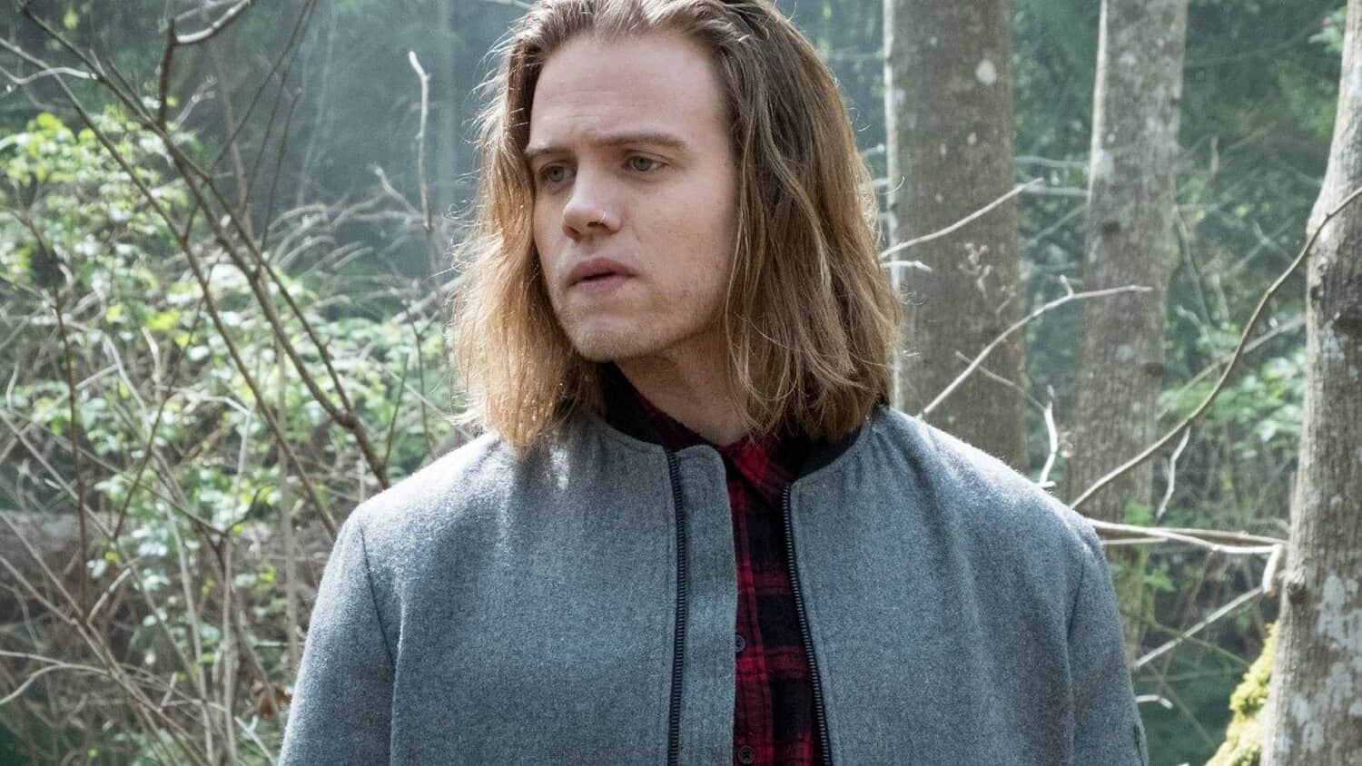 philip-stands-in-a-forest-in-travelers.jpeg