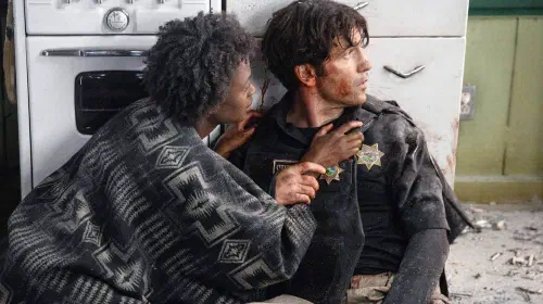 assets/jon-bernthal-bloody-in-those-who-wish-me-dead-with-a-woman-touching-him.jpeg