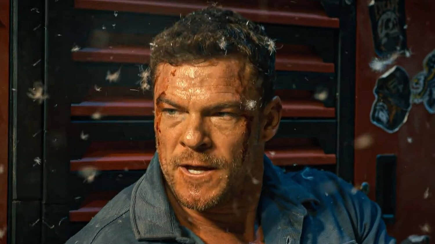 alan-ritchson-s-hank-looking-mad-with-feathers-floating-around-him-in-runner.jpeg