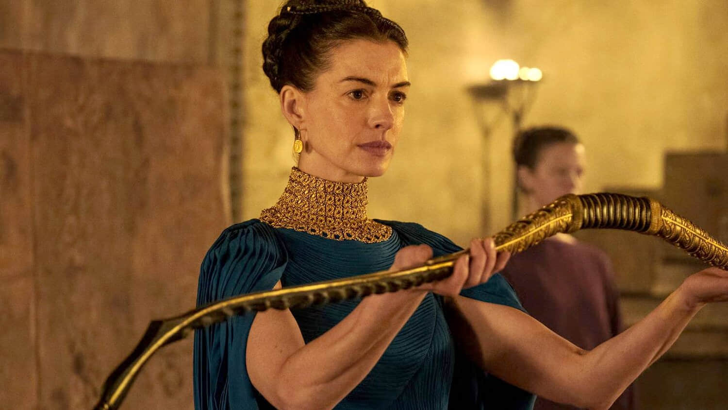 anne-hathaway-holding-out-a-bow-in-the-odyssey.jpeg