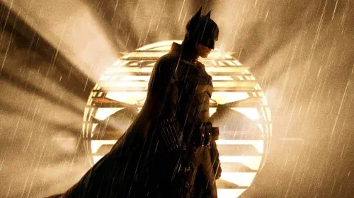 assets/robert-pattinson-as-batman-standing-in-front-of-the-bat-signal-in-the-batman.jpeg