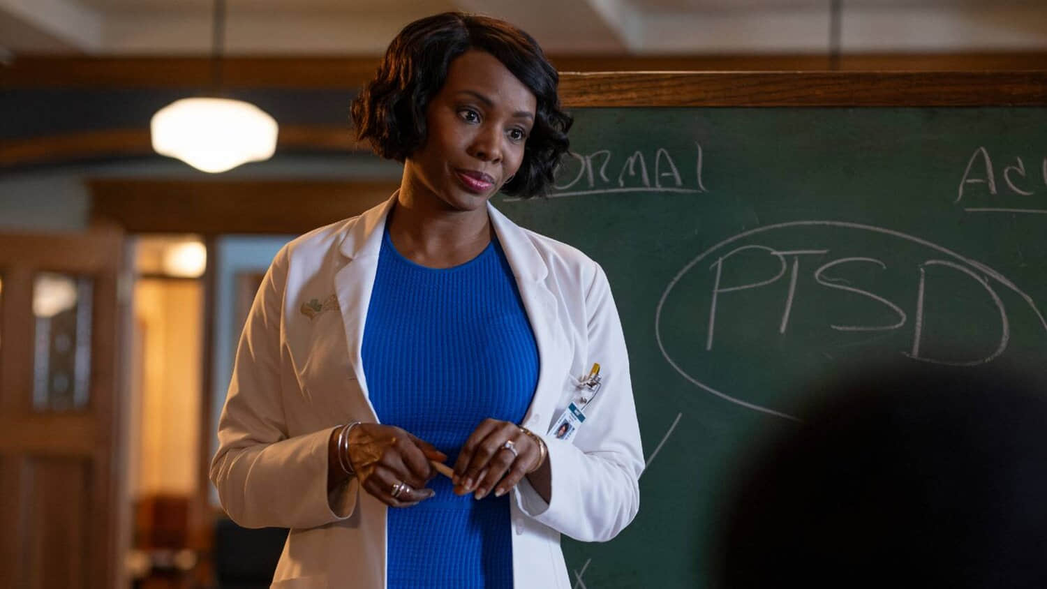 tamberla-perry-standing-in-front-of-a-chalkboard-in-brilliant-minds.jpeg