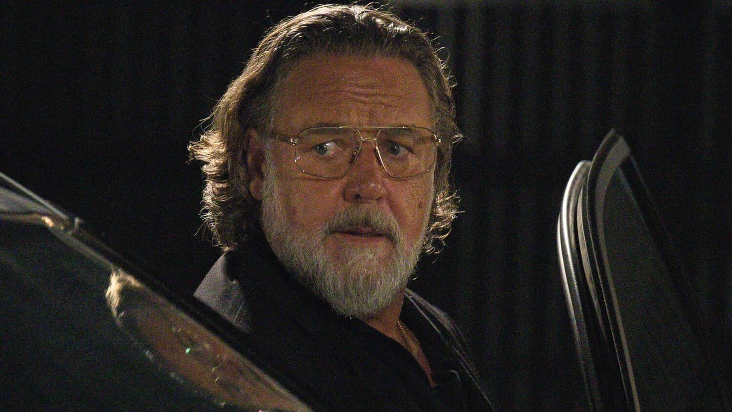 russell-crowe-as-marco-standing-next-to-a-car-in-the-get-out-movie.jpeg