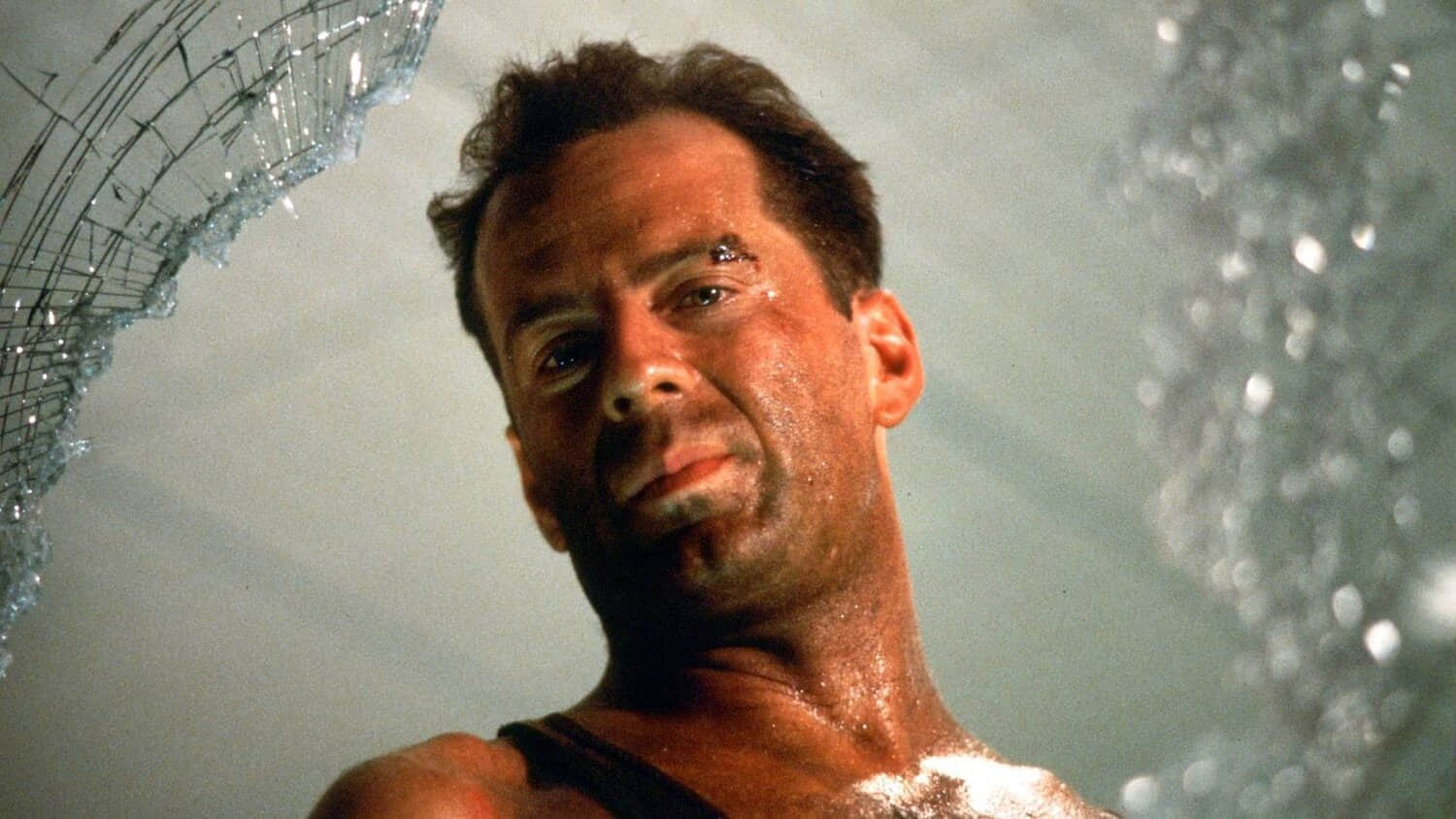 bruce-willis-as-mcclane-looking-through-a-hole-in-a-window-in-die-hard.jpeg