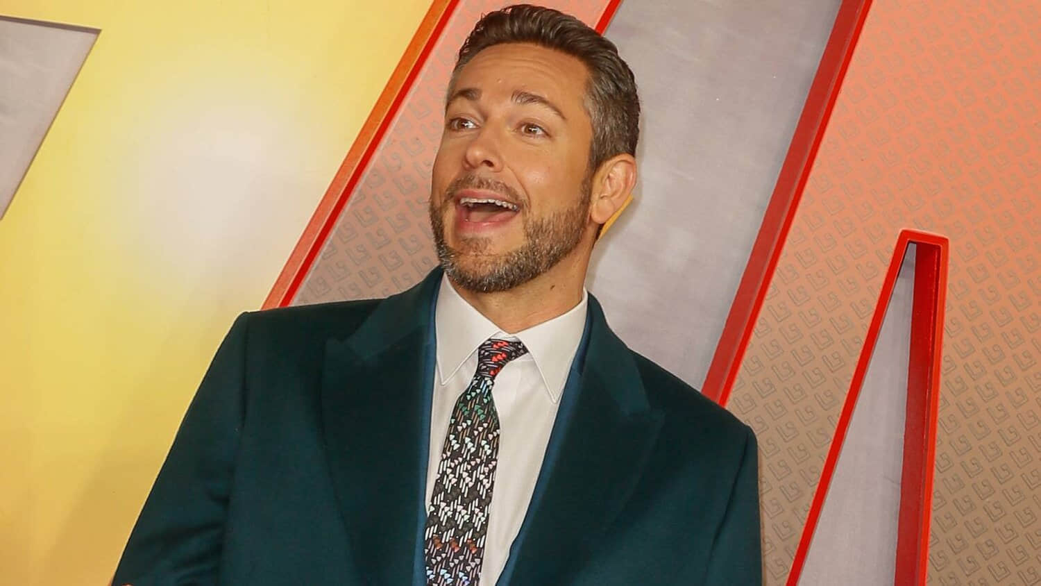 zachary-levi-smiling-widely-on-a-red-carpet-for-shazam.jpeg